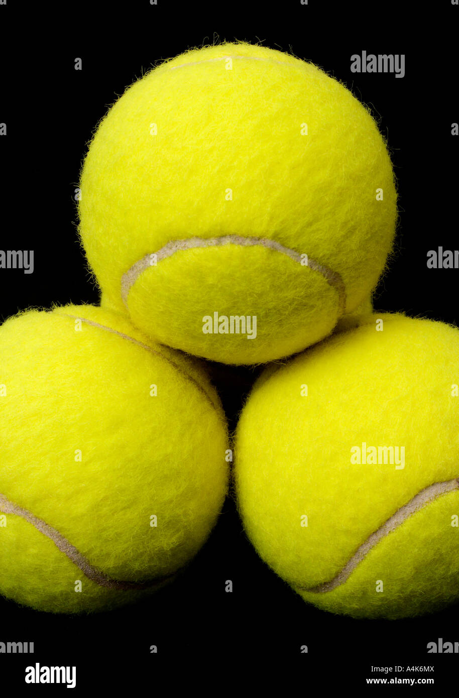 Yellow tennis balls isolated on a black background Stock Photo - Alamy