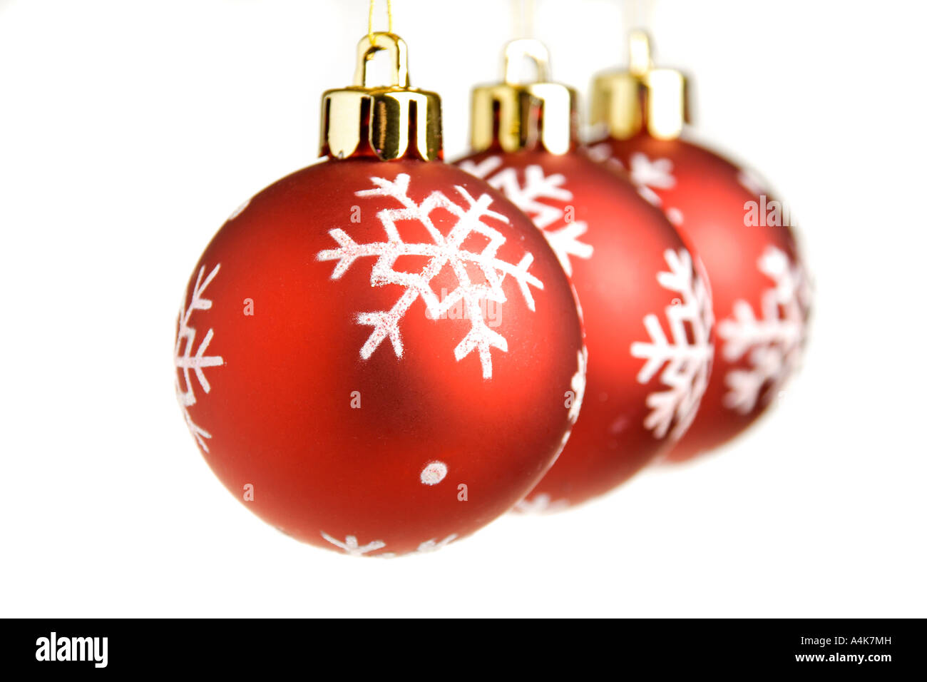 Three red Christmas balls in a row isolated on a white background ...