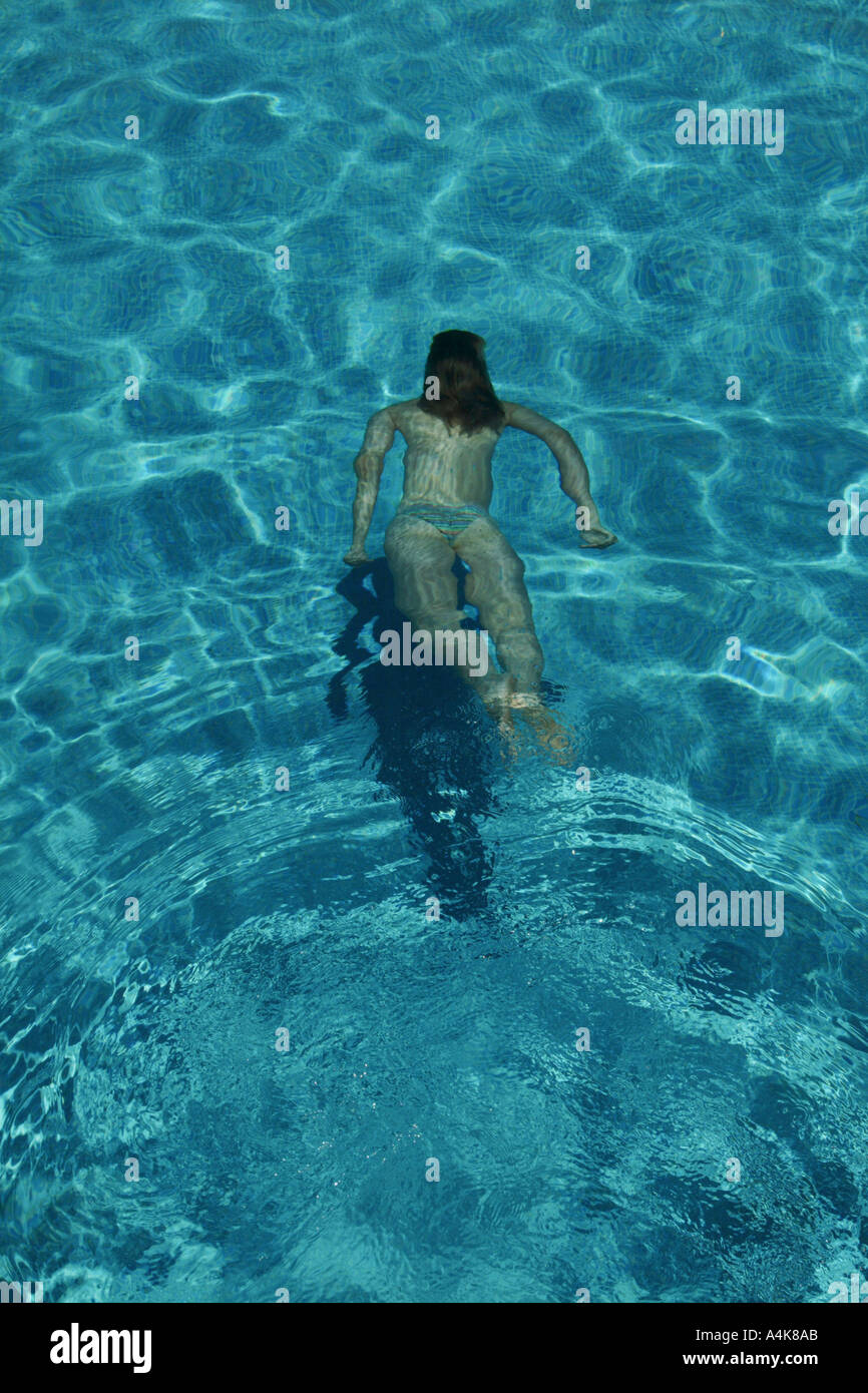 Woman in bikini swimming underwater in a pool Stock Photo - Alamy