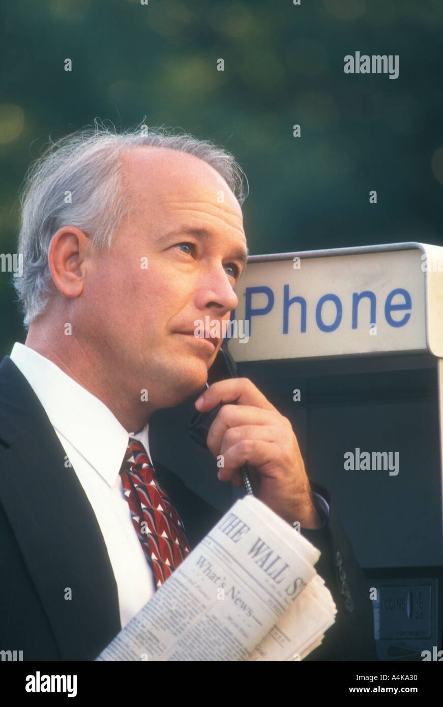 businessman talking on pay phone Stock Photo
