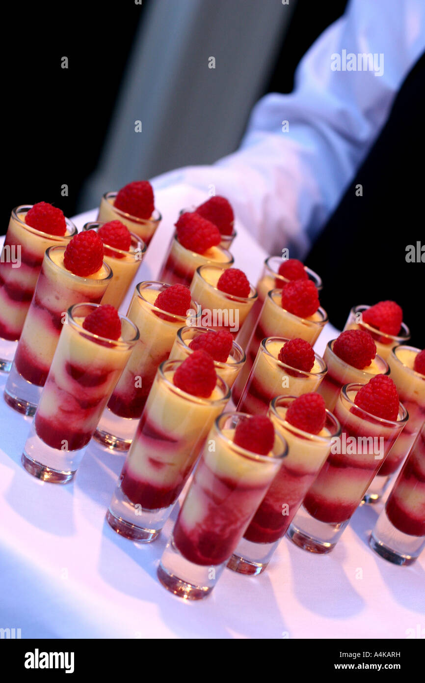 Waiter brings out big batch of tasty treats Stock Photo