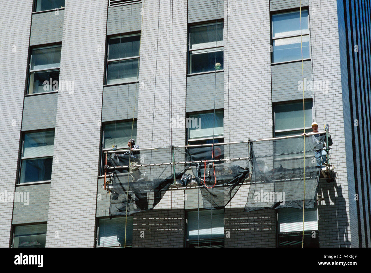 Window cleaning scaffold on side of building Stock Photo