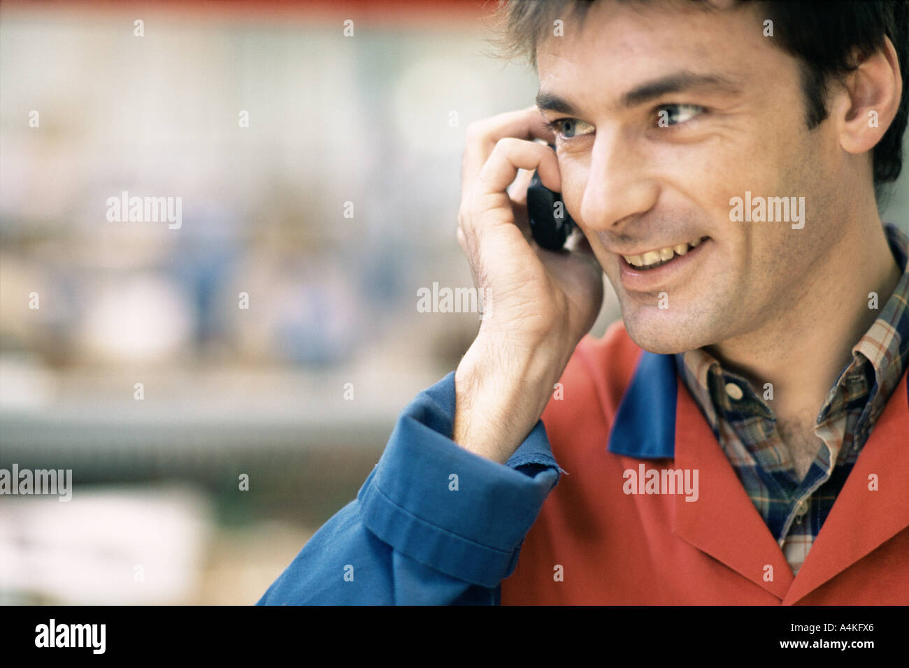 Manual worker using cell phone Stock Photo