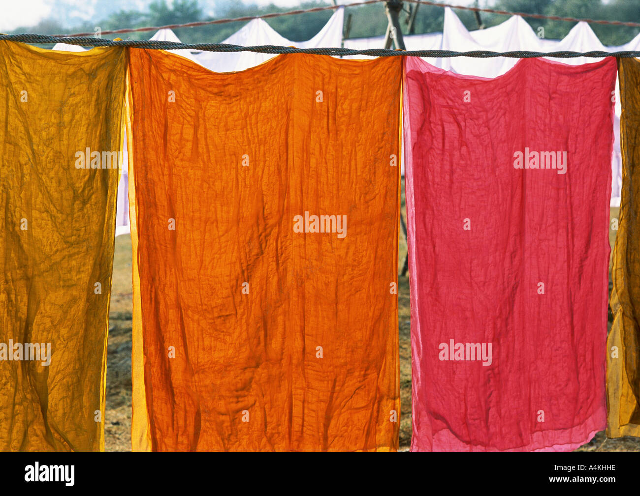 India, Uttar Pradesh, colored sheets hanging on clothesline Stock