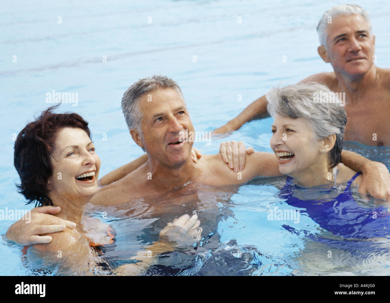 Mature couples in pool Stock Photo