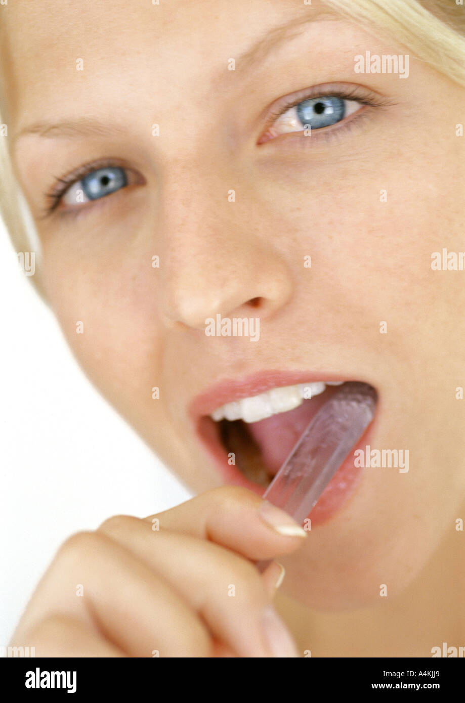 Young woman brushing teeth Stock Photo