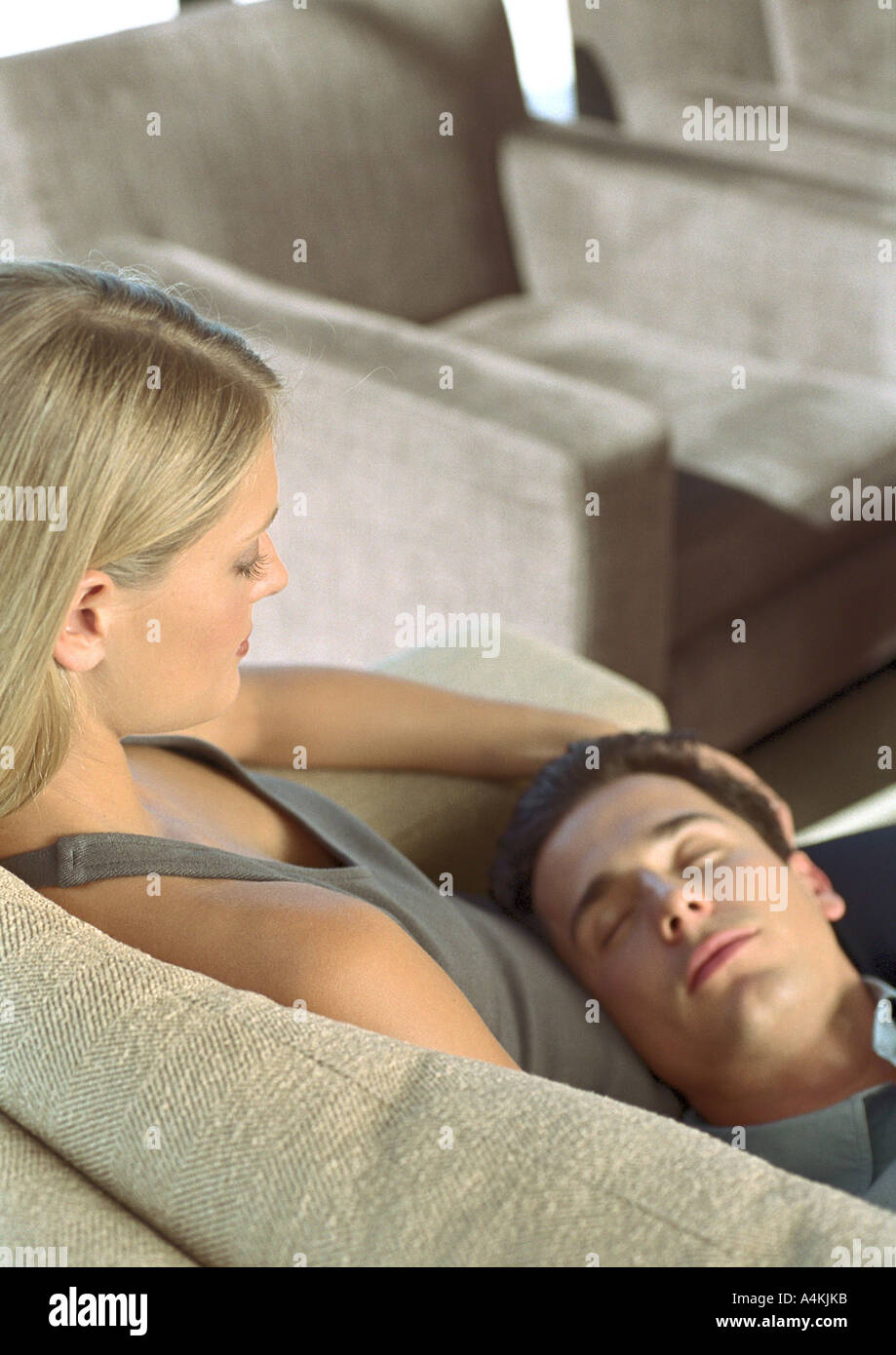 Man sleeping with head on woman's lap Stock Photo - Alamy