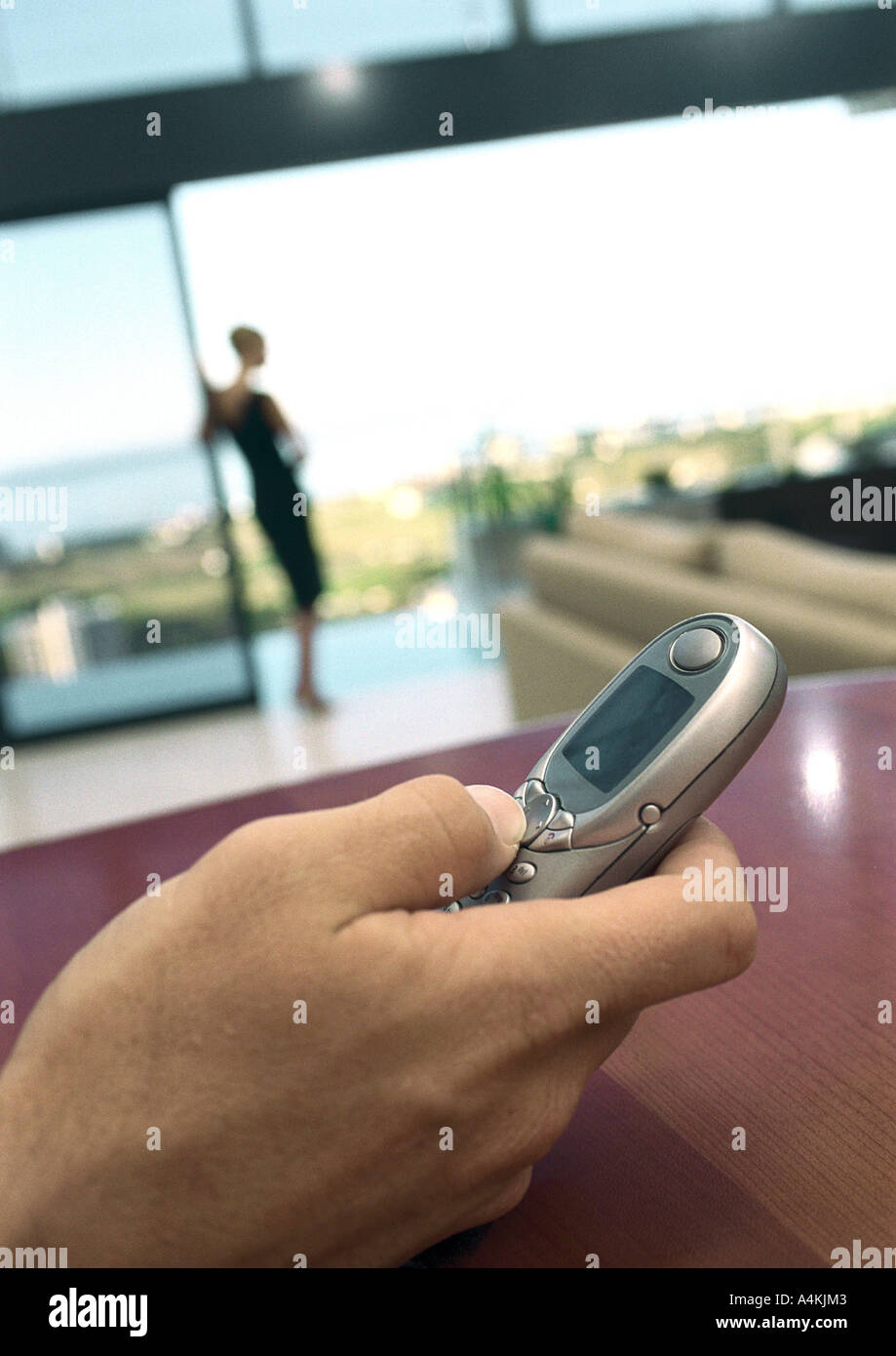 Man's hand holding cell phone Stock Photo