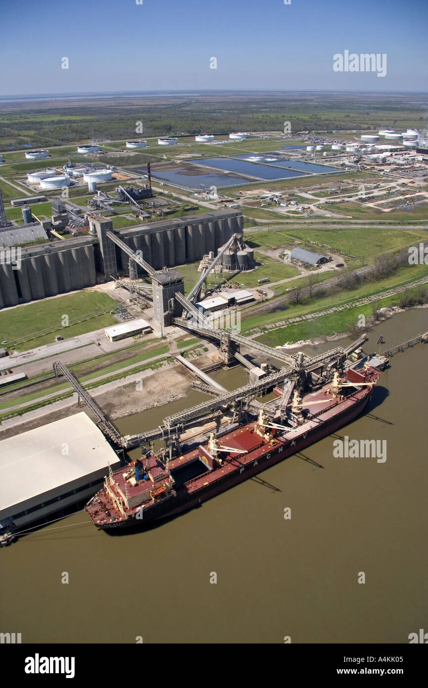 Grain elevators and river barge being loaded along the Mississippi