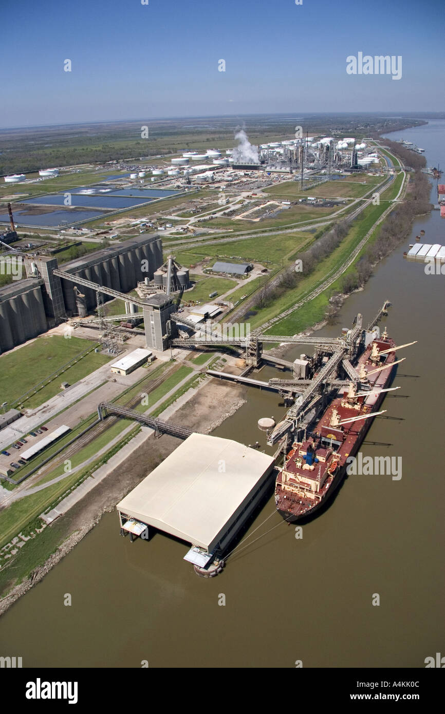 Grain elevators and river barge being loaded along the Mississippi