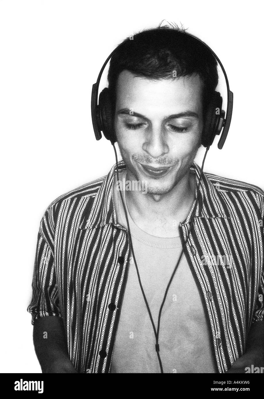 Man listening to headphones, smiling, portrait Stock Photo
