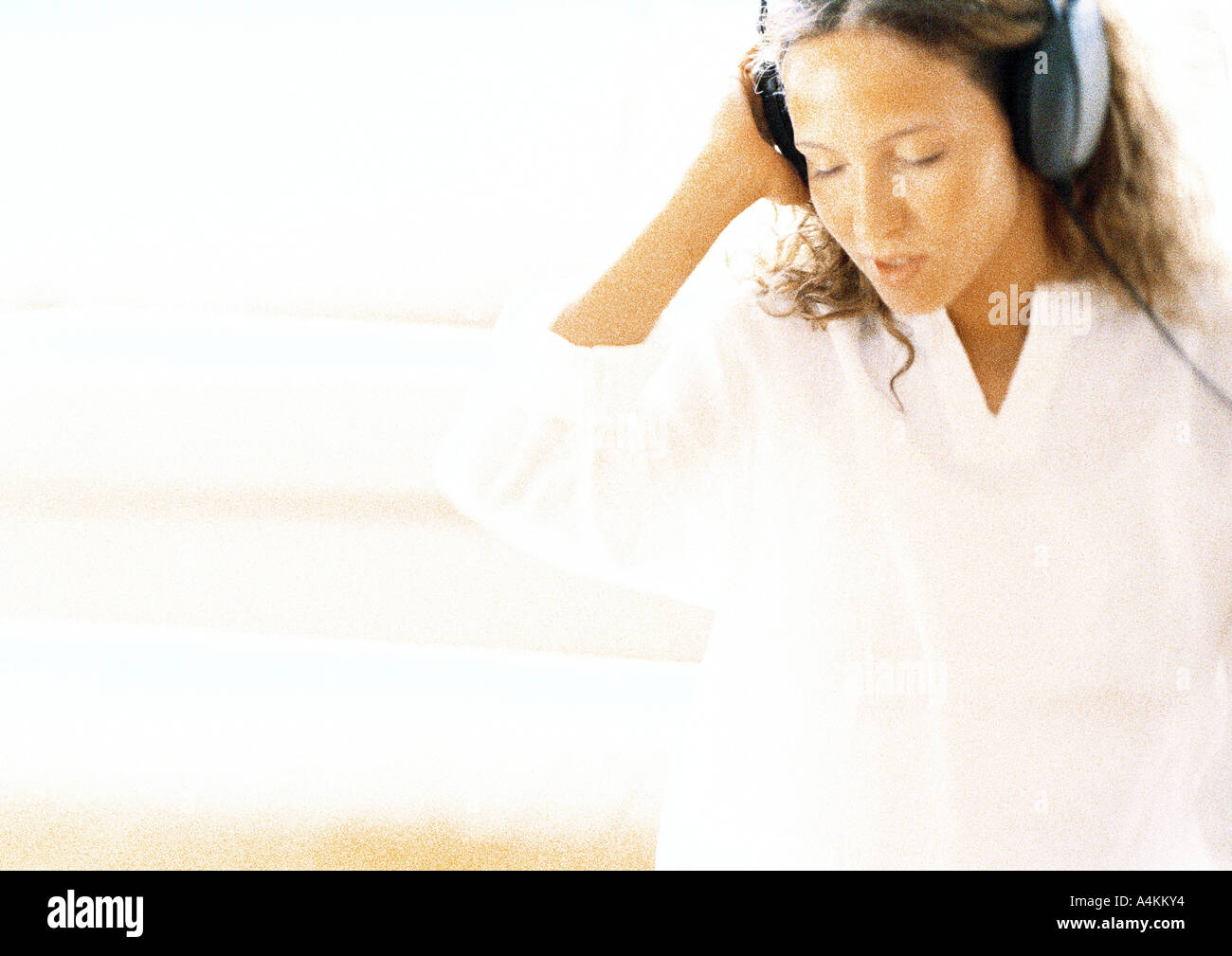 A woman wearing headphones, her gaze directed away, embodying the quiet resistance to forced social interaction.