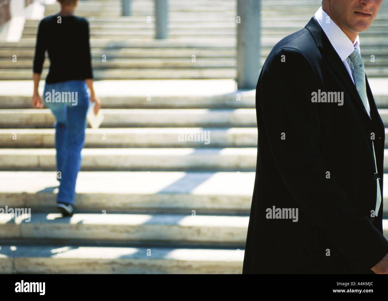 Businessman standing in front of stairs Stock Photo