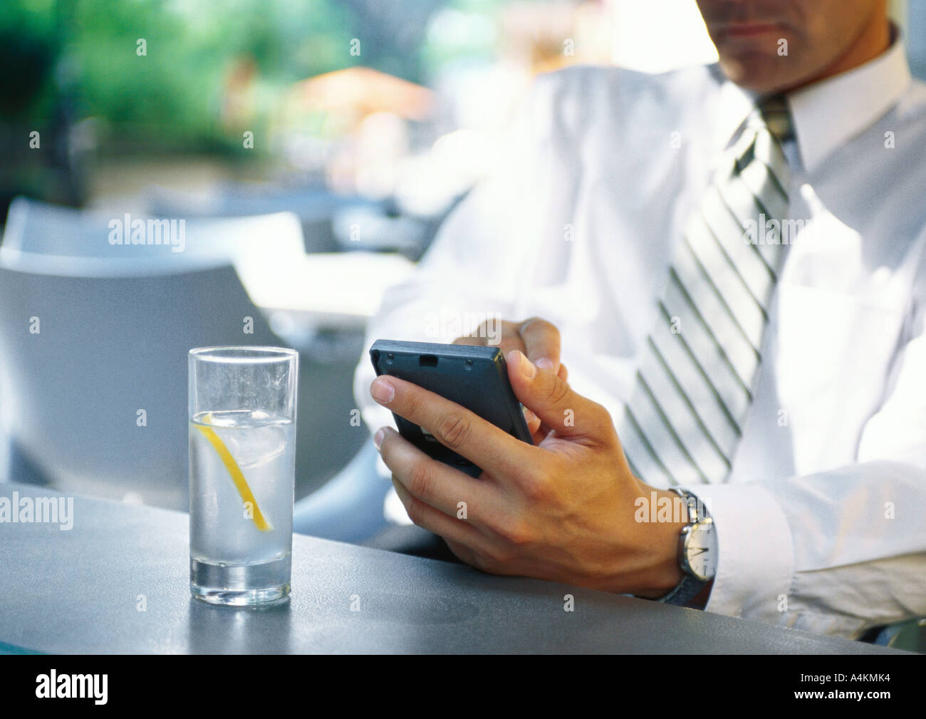 Businesman using electronic organizer in restaurant Stock Photo