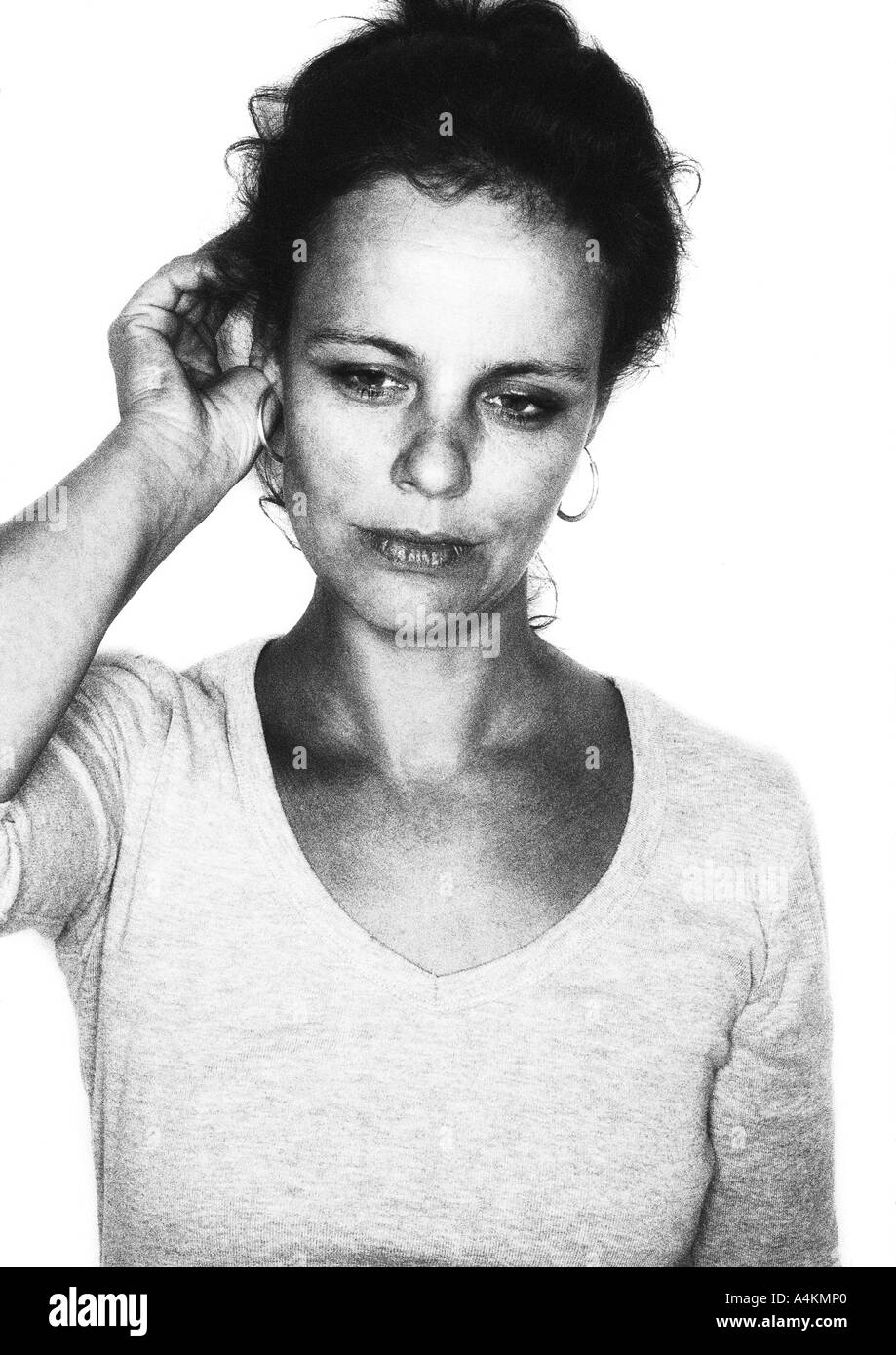 Woman with hand to ear, portrait, b&w. Stock Photo