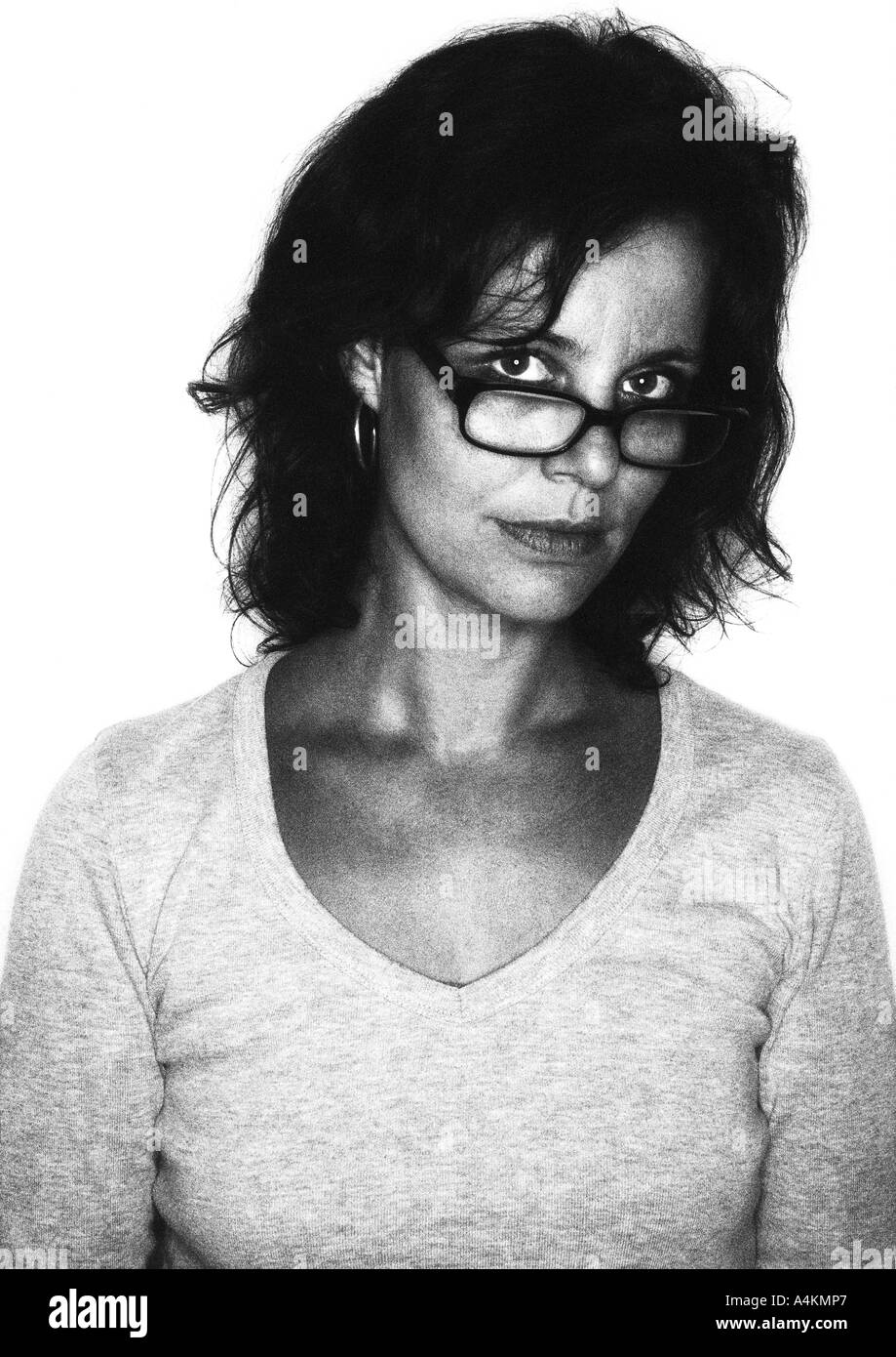 Serious girl looking over glasses Black and White Stock Photos & Images