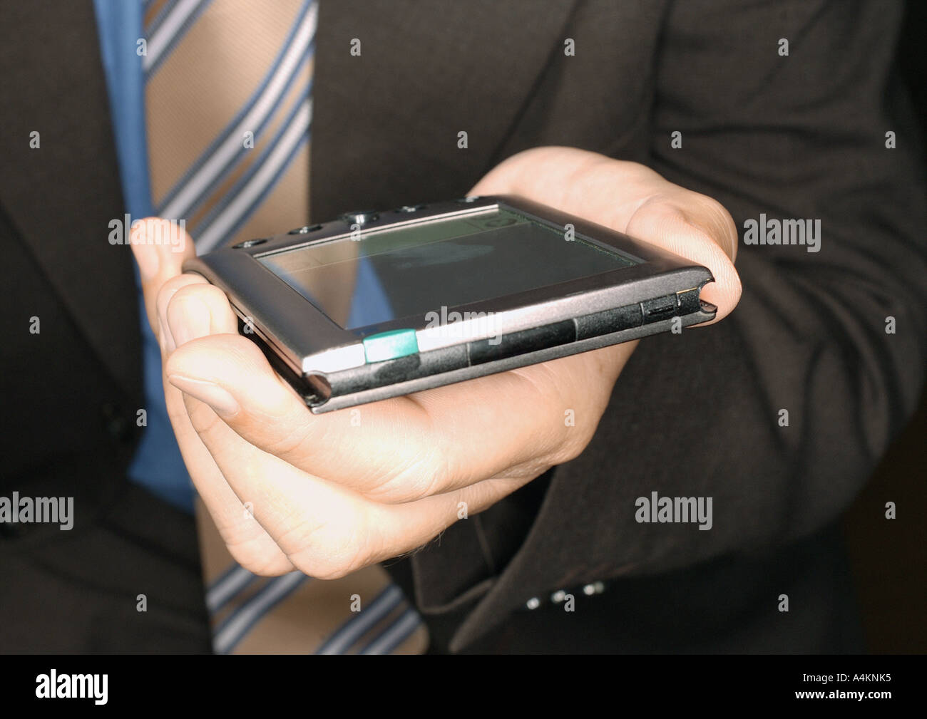 Businessman holding electronic organizer, close-up Stock Photo