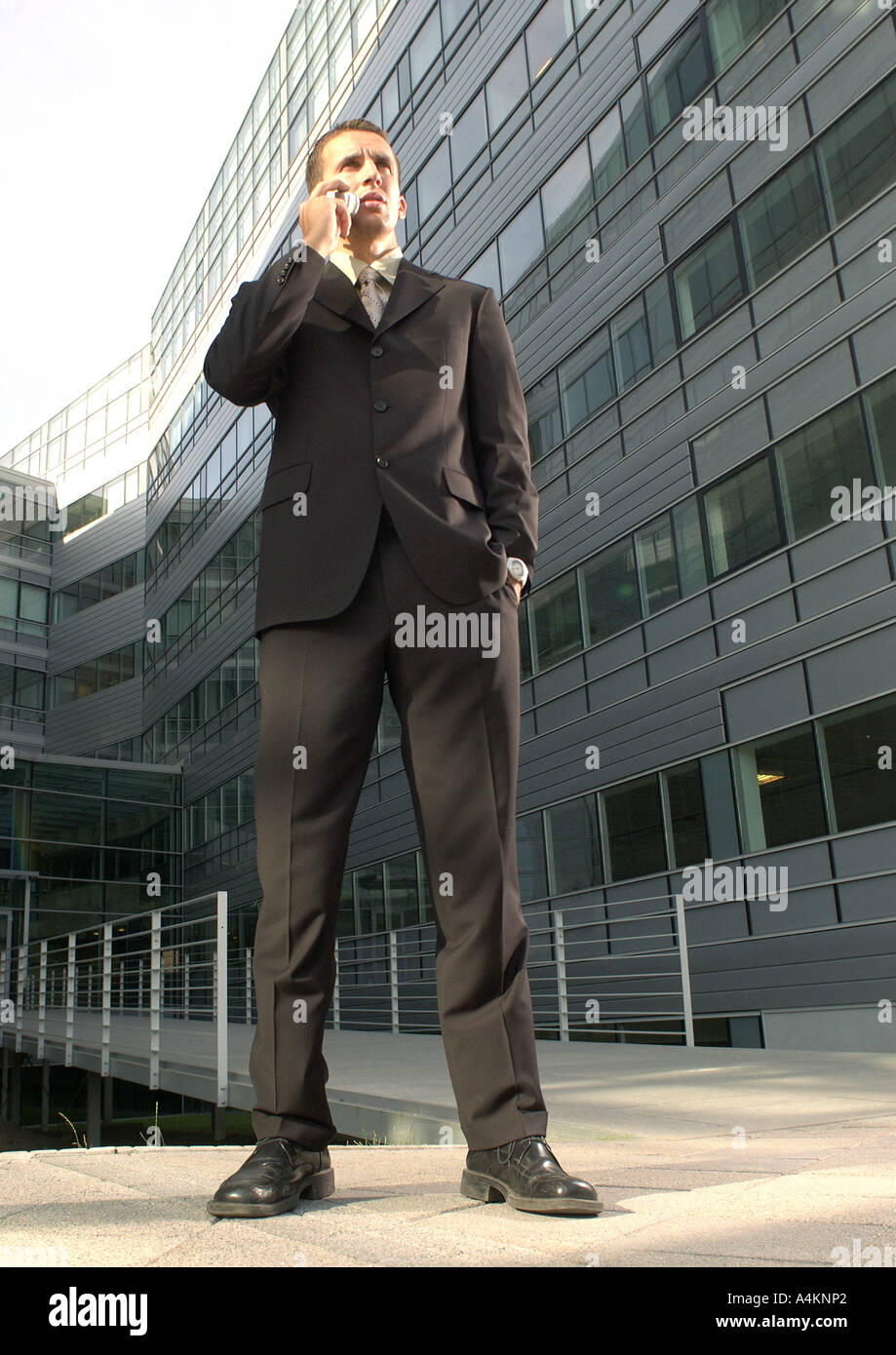 Businessman holding cell phone, low angle view Stock Photo