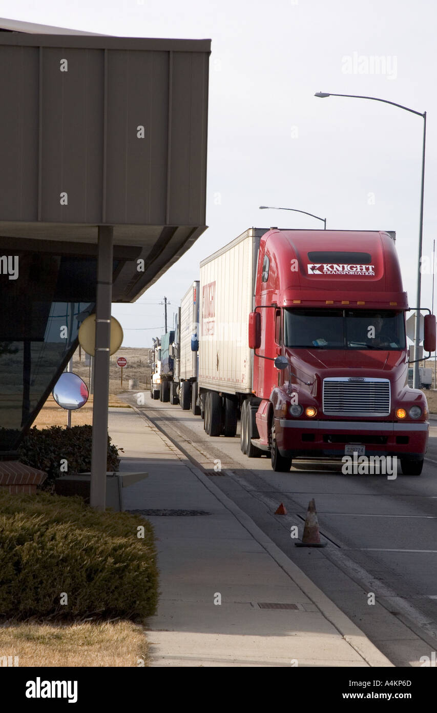 Long haul trucks line up a weigh station Stock Photo Alamy