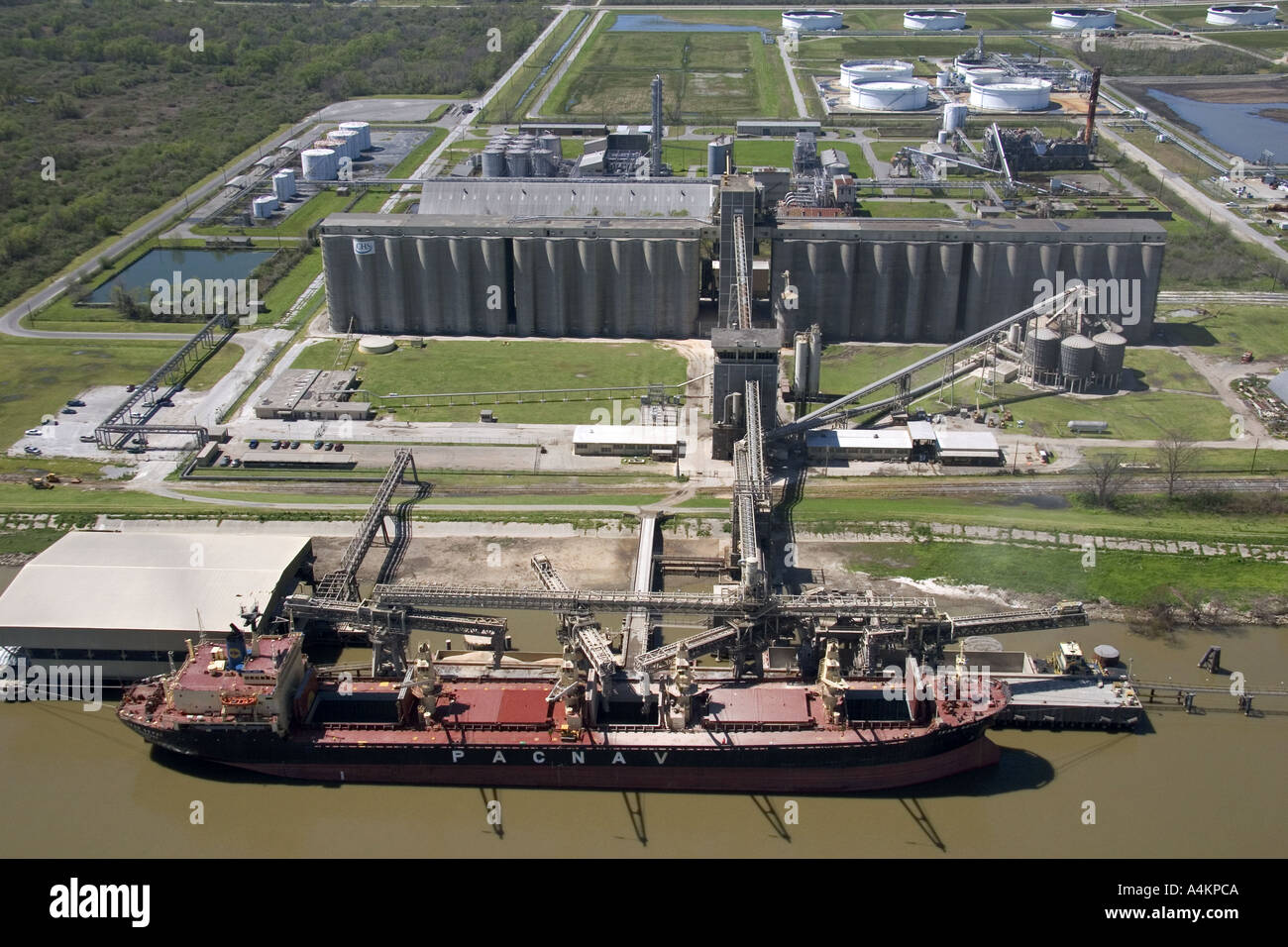 Grain elevators and river barge being loaded along the Mississippi