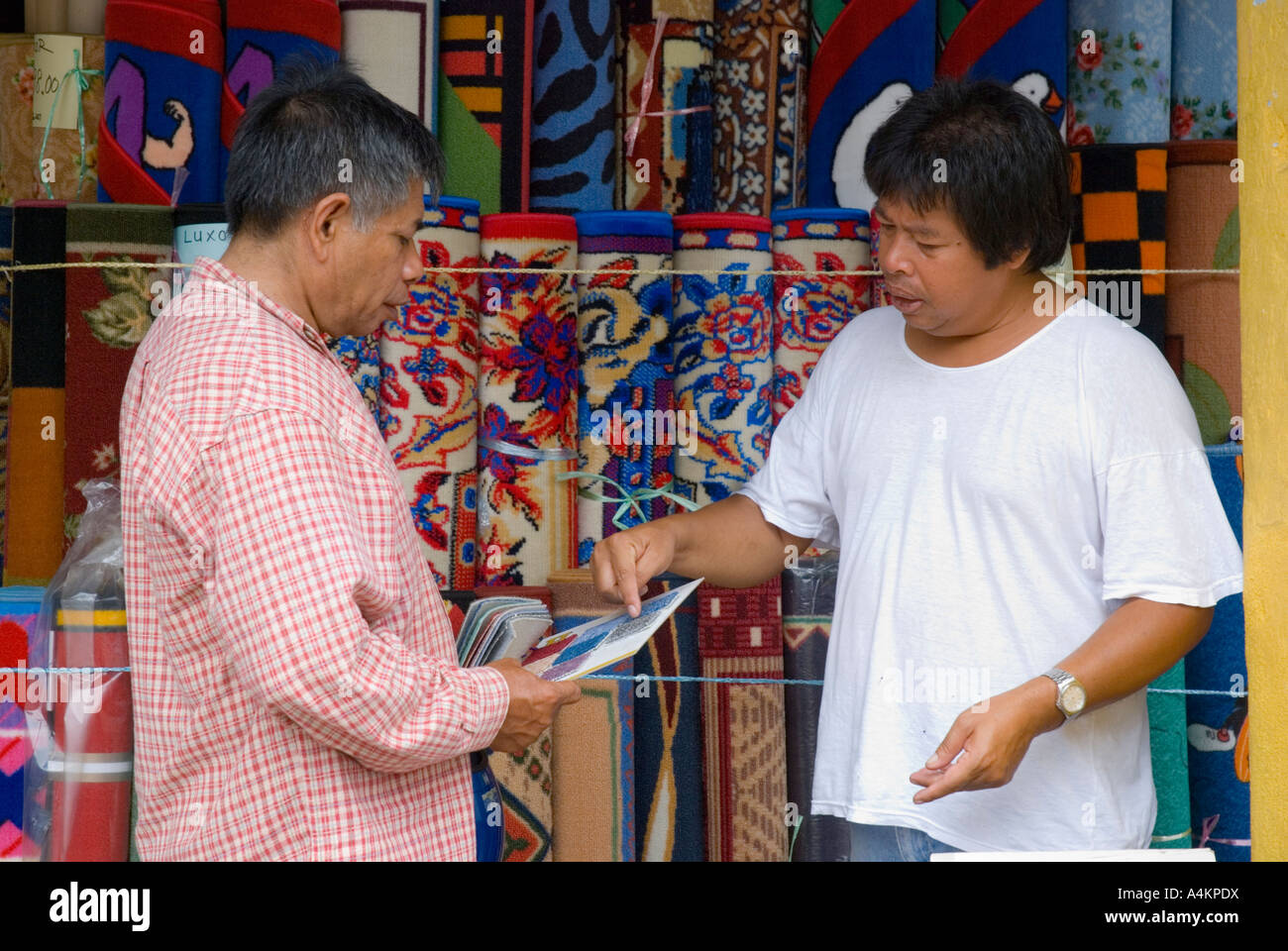 Carpet and rug salesman and customer Johor Bahru Malaysia Stock Photo