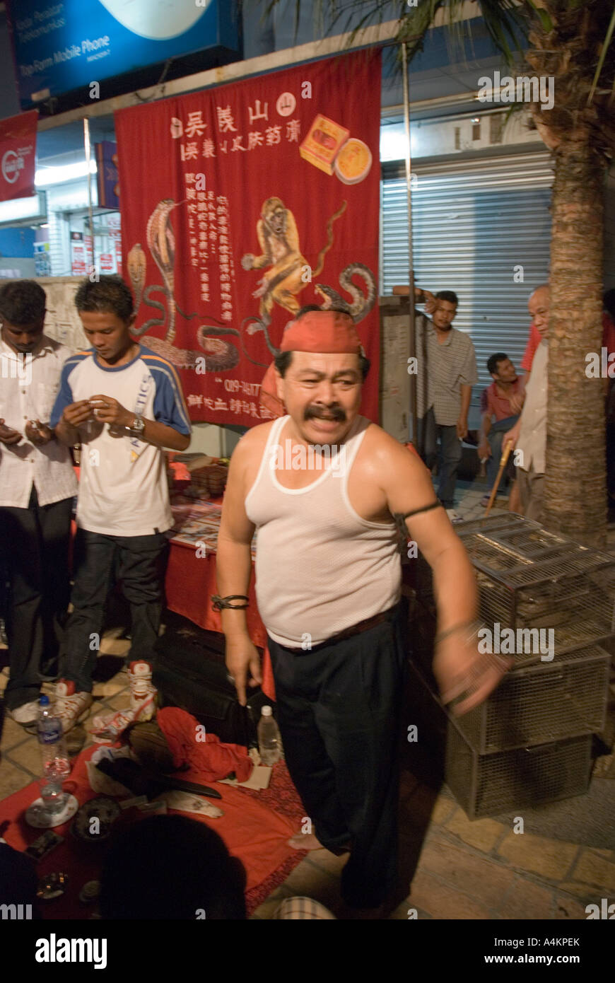 An Indonesian Snake Oil Salesman Draws A Crowd Of Interested Punters In Johor Bahru Malaysia Stock Photo Alamy