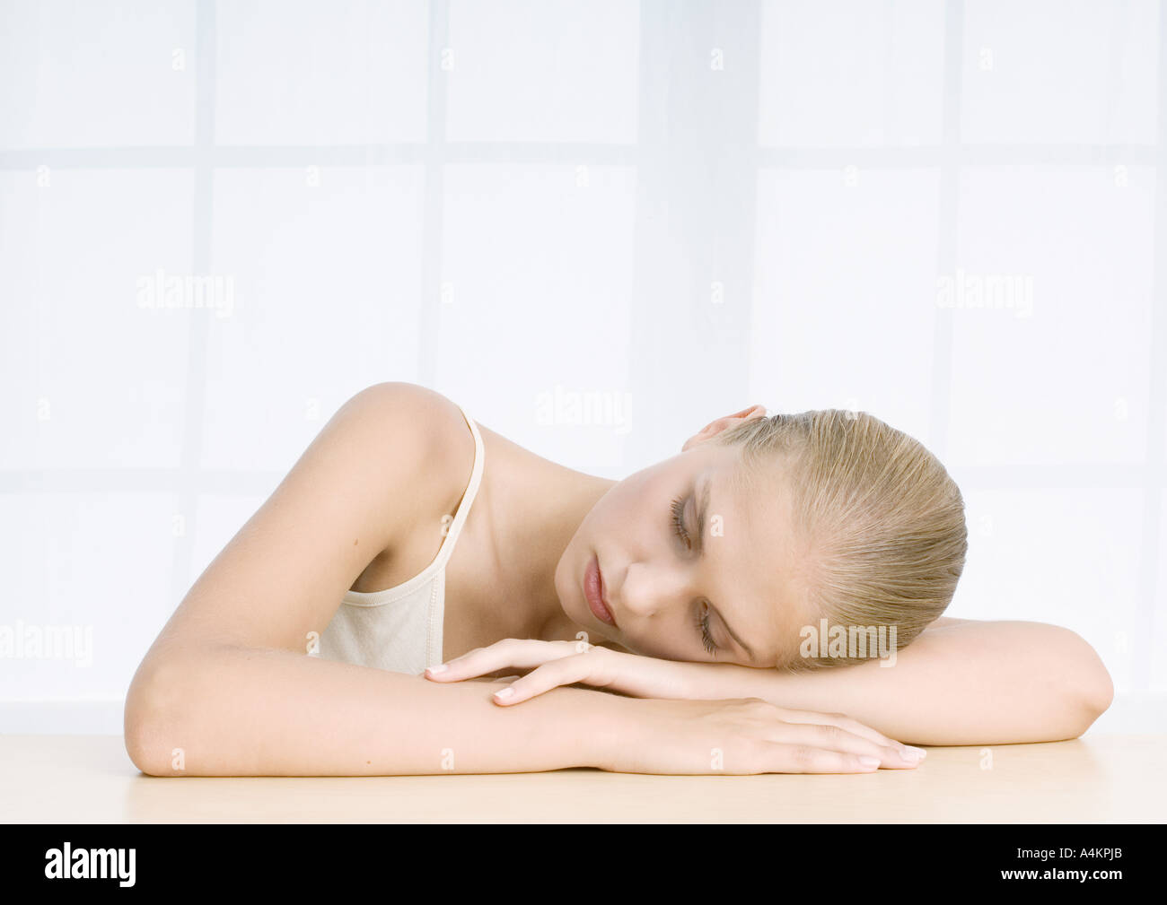 Resting Head Woman resting head on arms Stock Photo - Alamy