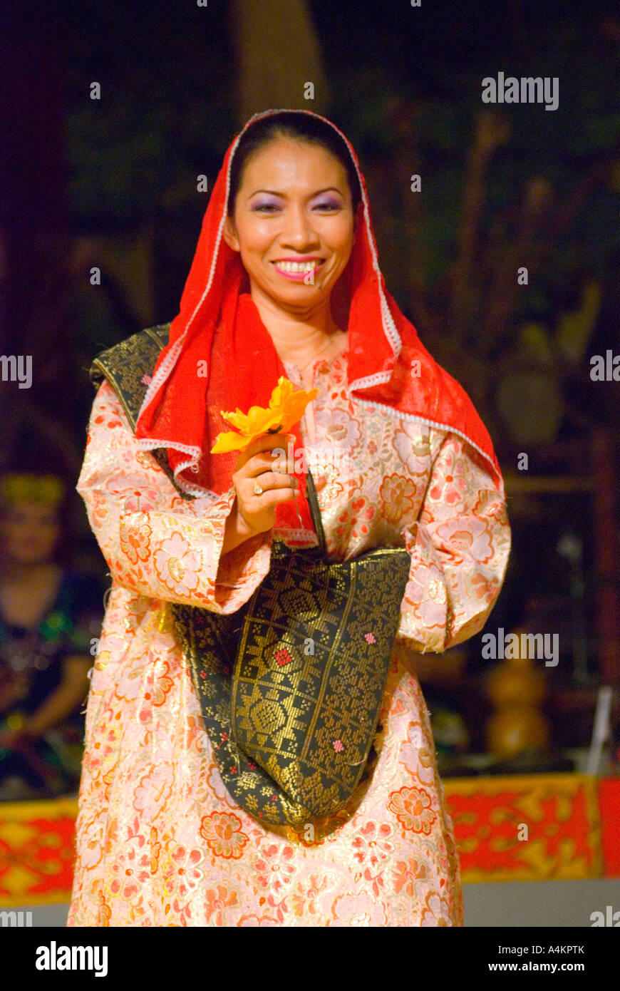 A dancer at the Sarawak Cultural Centre wearing traditional Malay Muslim dress Stock Photo