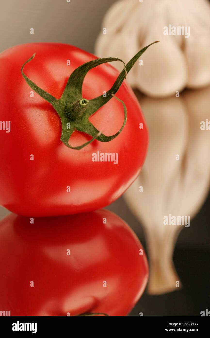 Single garlic clove and tomato Stock Photo - Alamy
