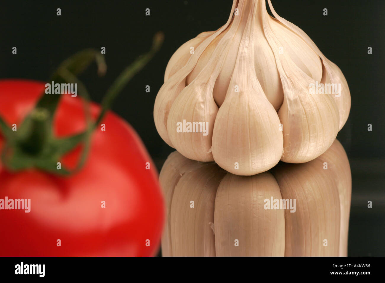 Single garlic clove and tomato Stock Photo - Alamy