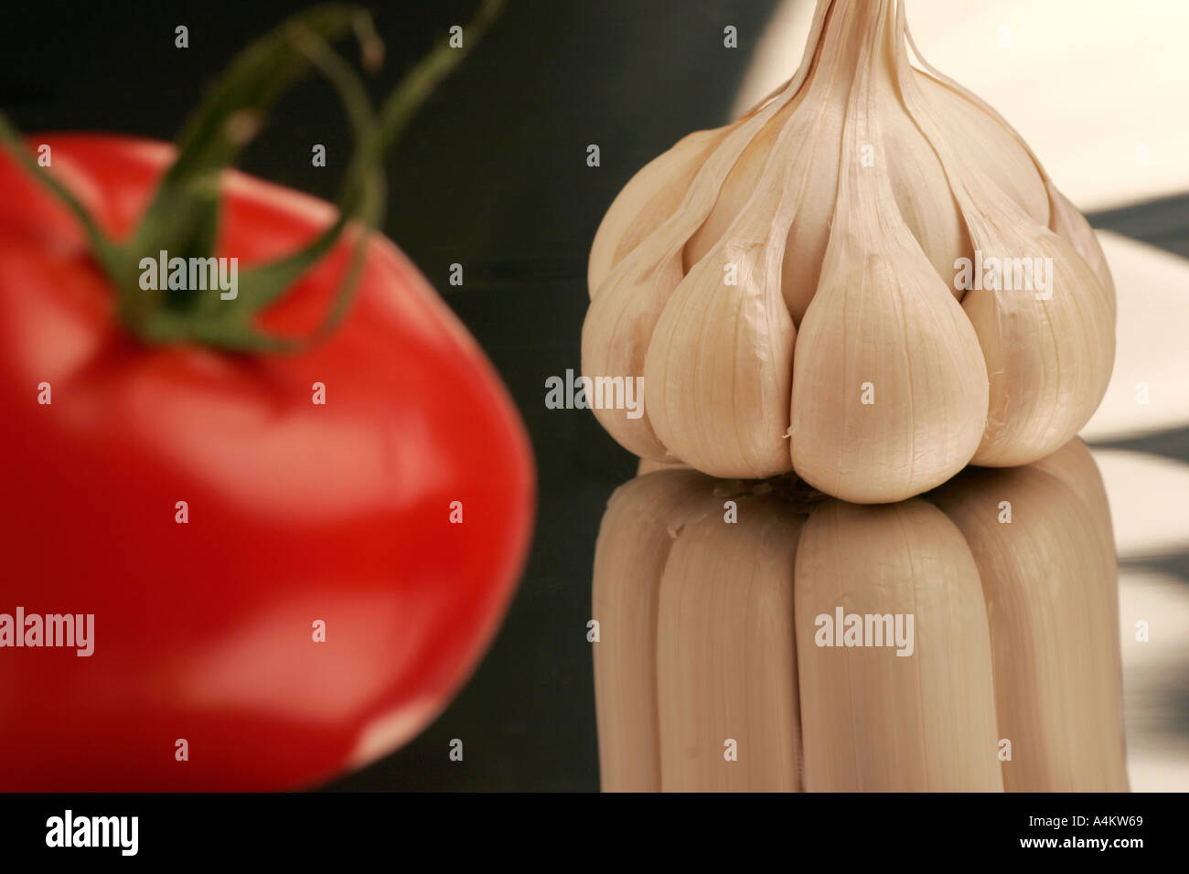 Single garlic clove and tomato Stock Photo - Alamy