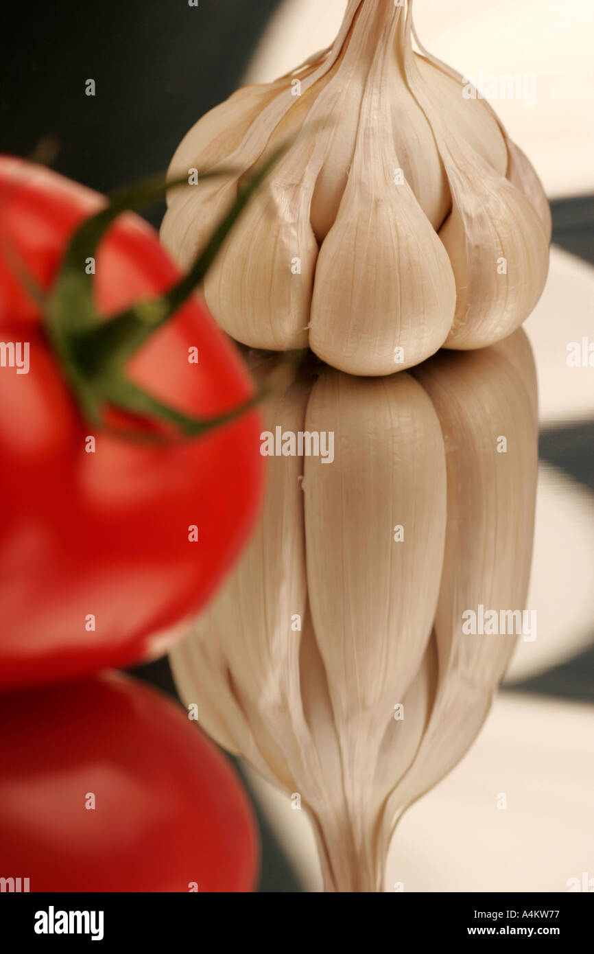 Single garlic clove and tomato Stock Photo - Alamy