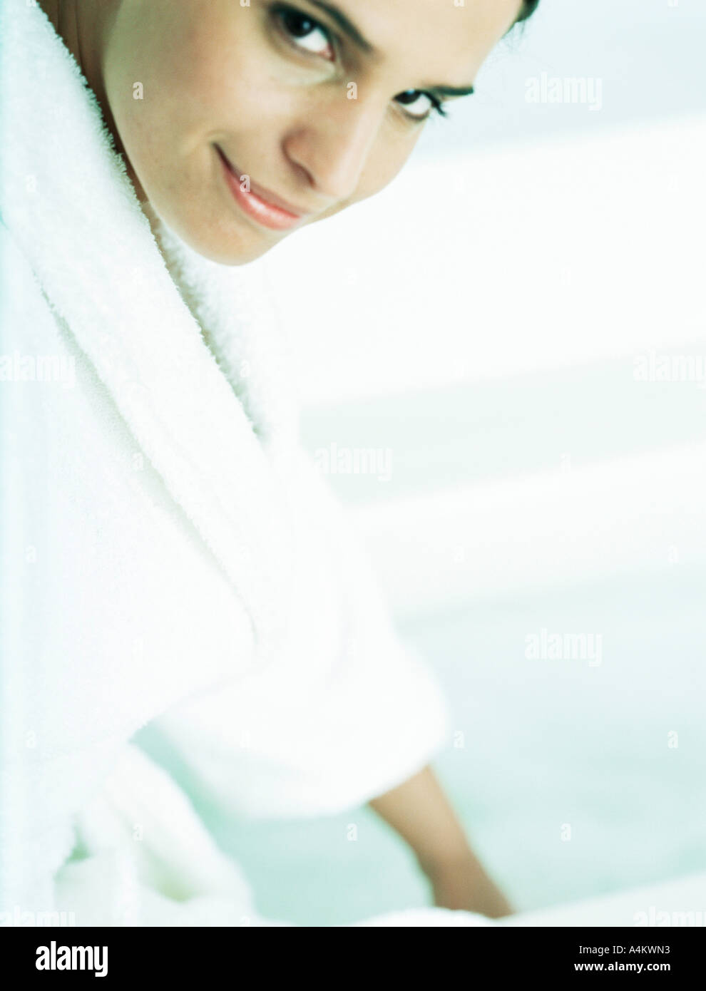 Woman in bathrobe looking at camera, partial view Stock Photo