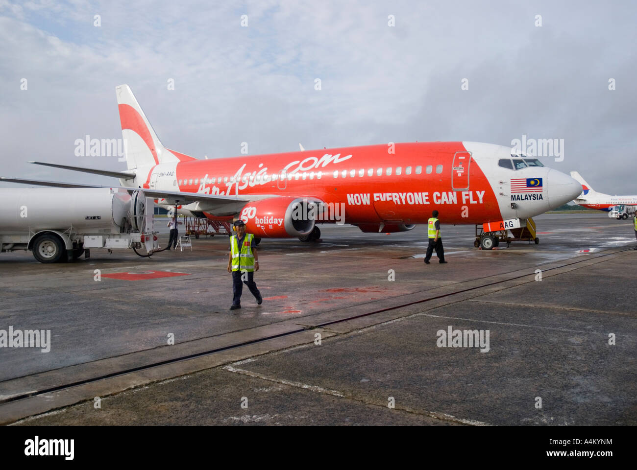 An Air Asia plane refuelling on the tarmac at Kuching in Sarawak Stock Photo