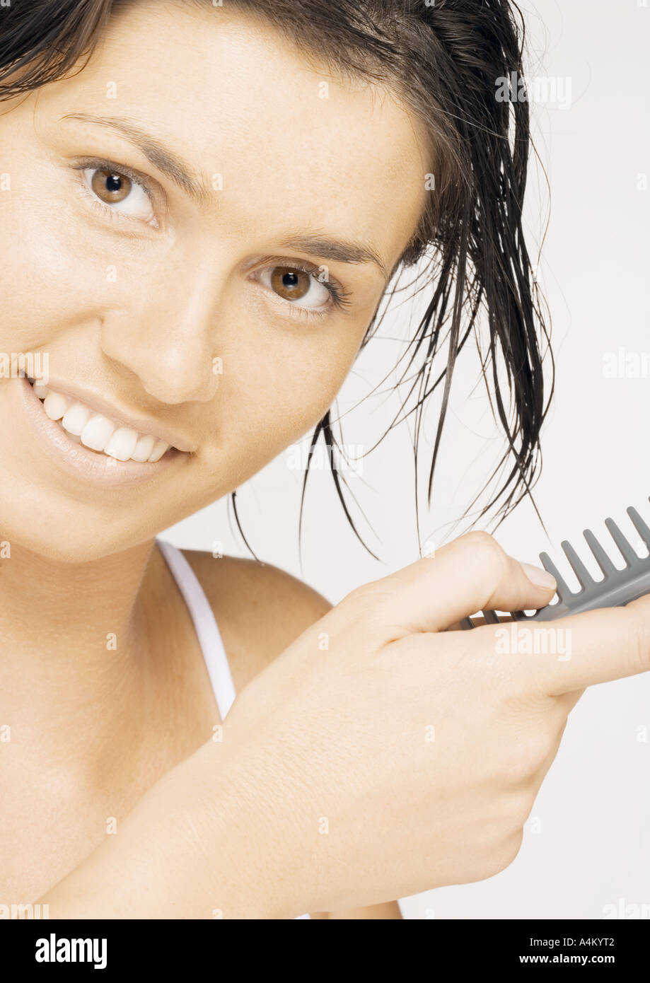 Woman combing wet hair Stock Photo Alamy