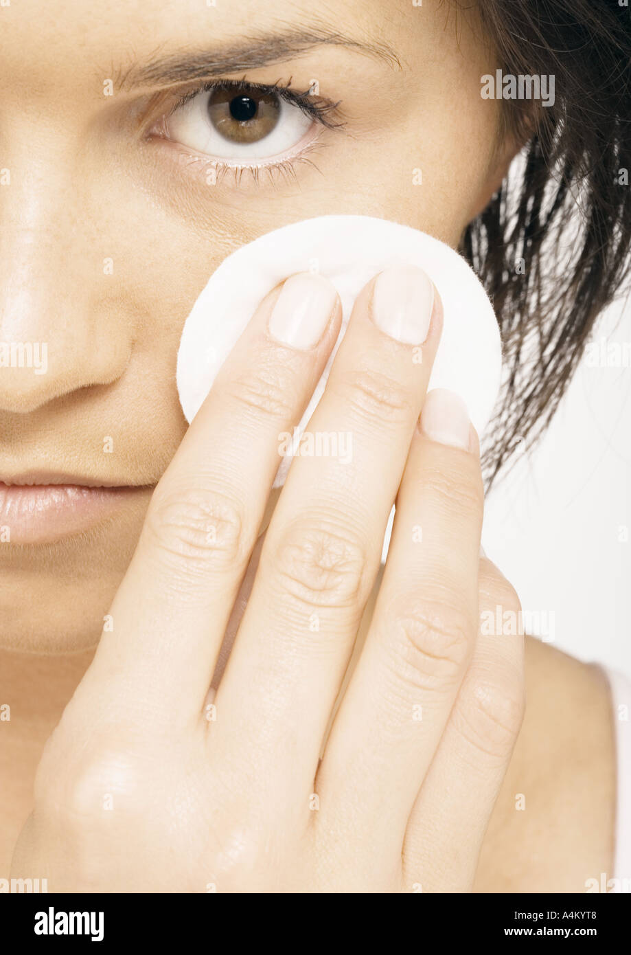Woman using cotton pad on face, closeup Stock Photo Alamy