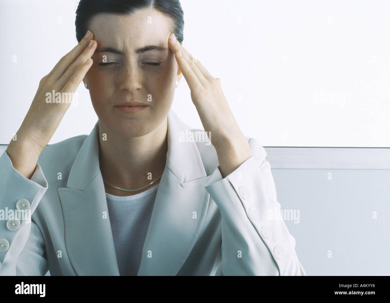 Young woman holding temples hi-res stock photography and images - Alamy