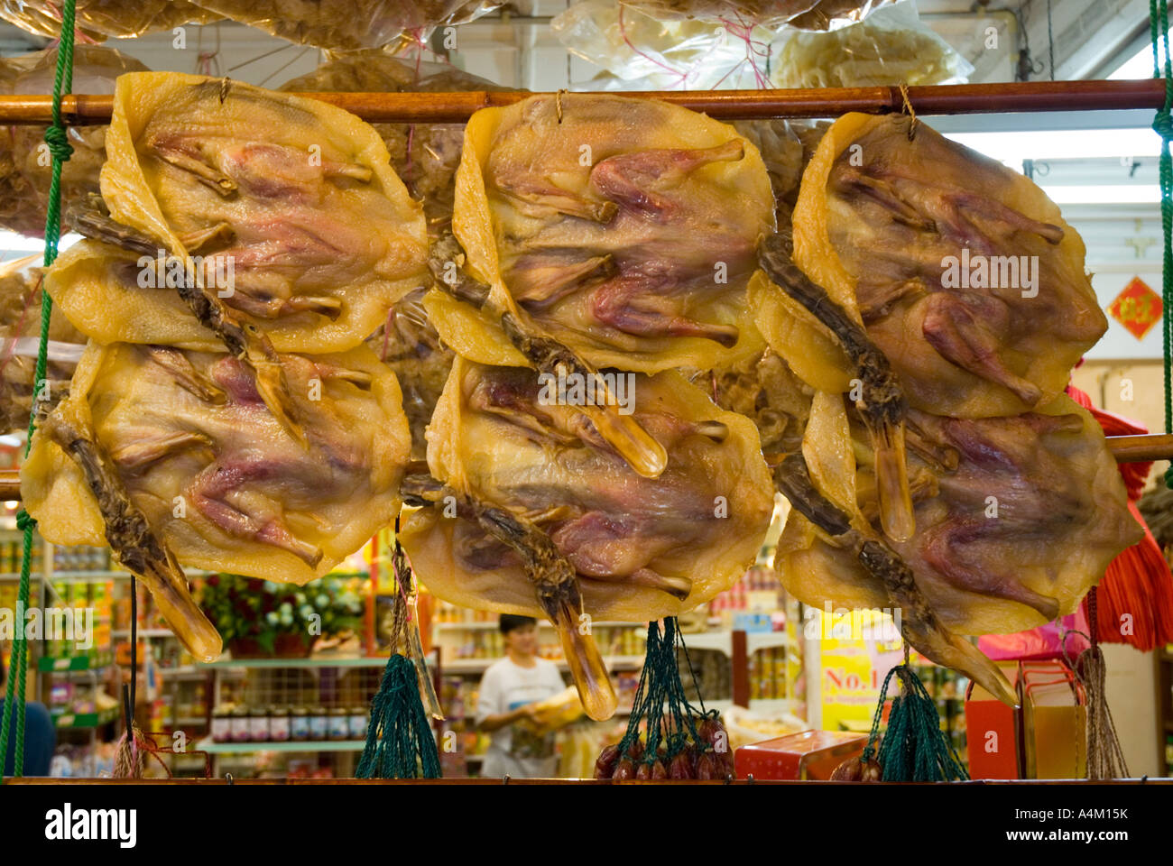 Pressed preserved duck hanging in the window of a Chinese general store in Malacca Stock Photo