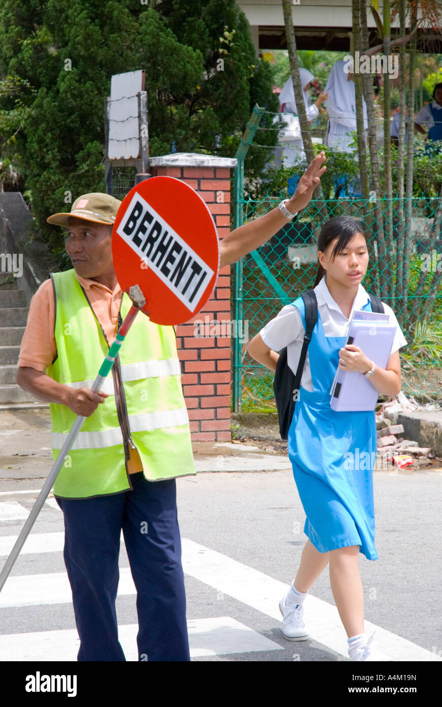 A Malaysian school crossing guard outside a Christian girls high school in Johor Bahru Malaysia Stock Photo