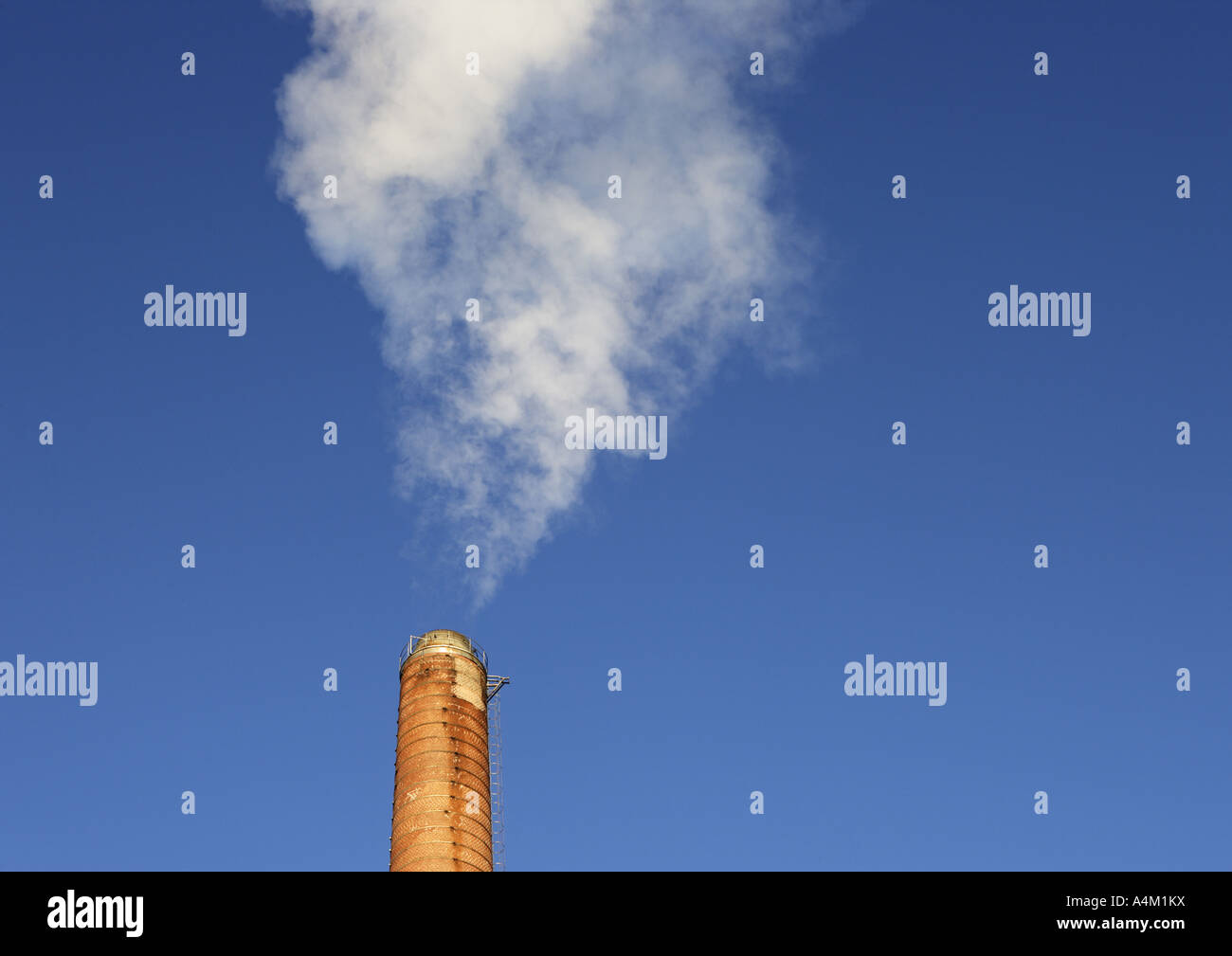Smoke from a brick chimney against blue sky Stock Photo - Alamy