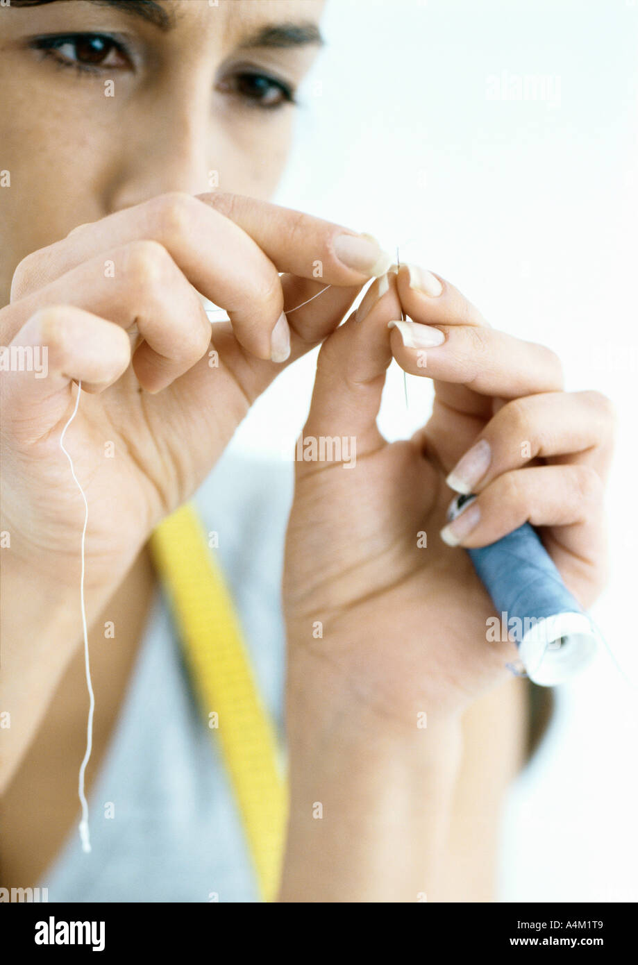 Woman threading needle Stock Photo Alamy