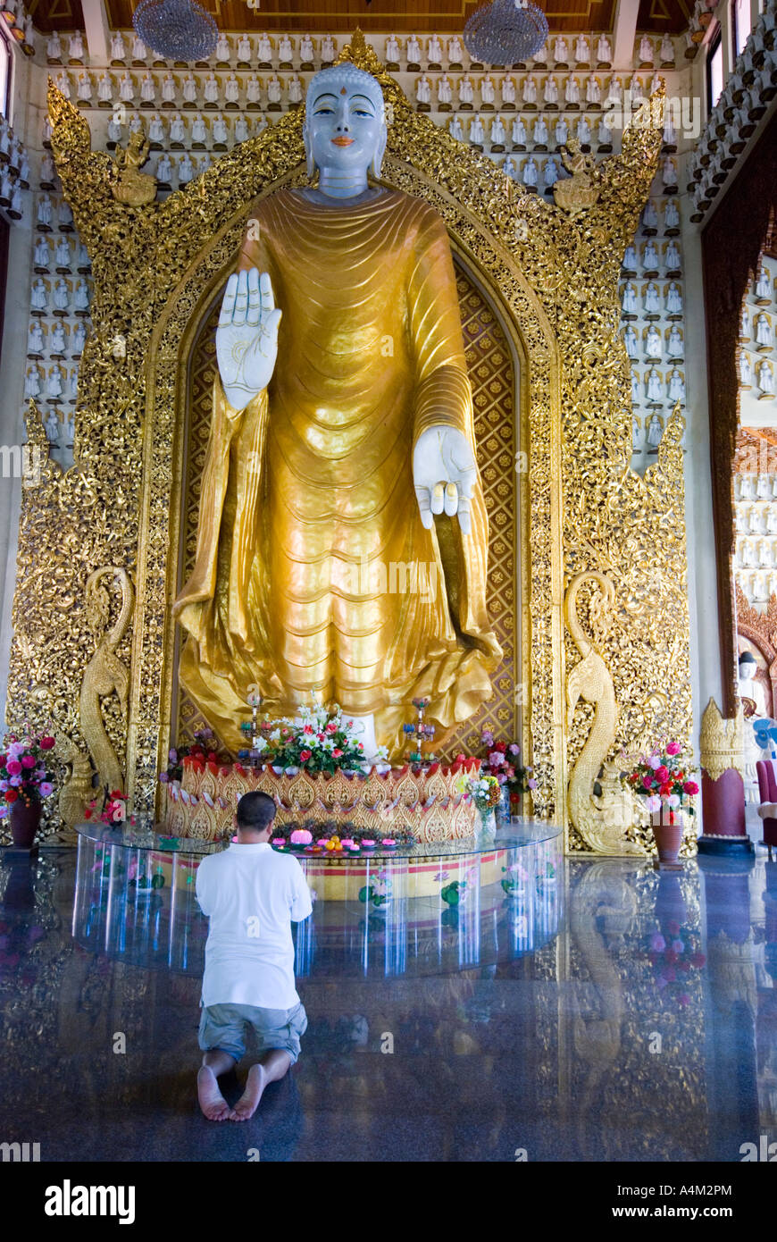 A man praying in the Dhammikarama Burmese Buddhist Temple in Penang which was built in 1805 Stock Photo