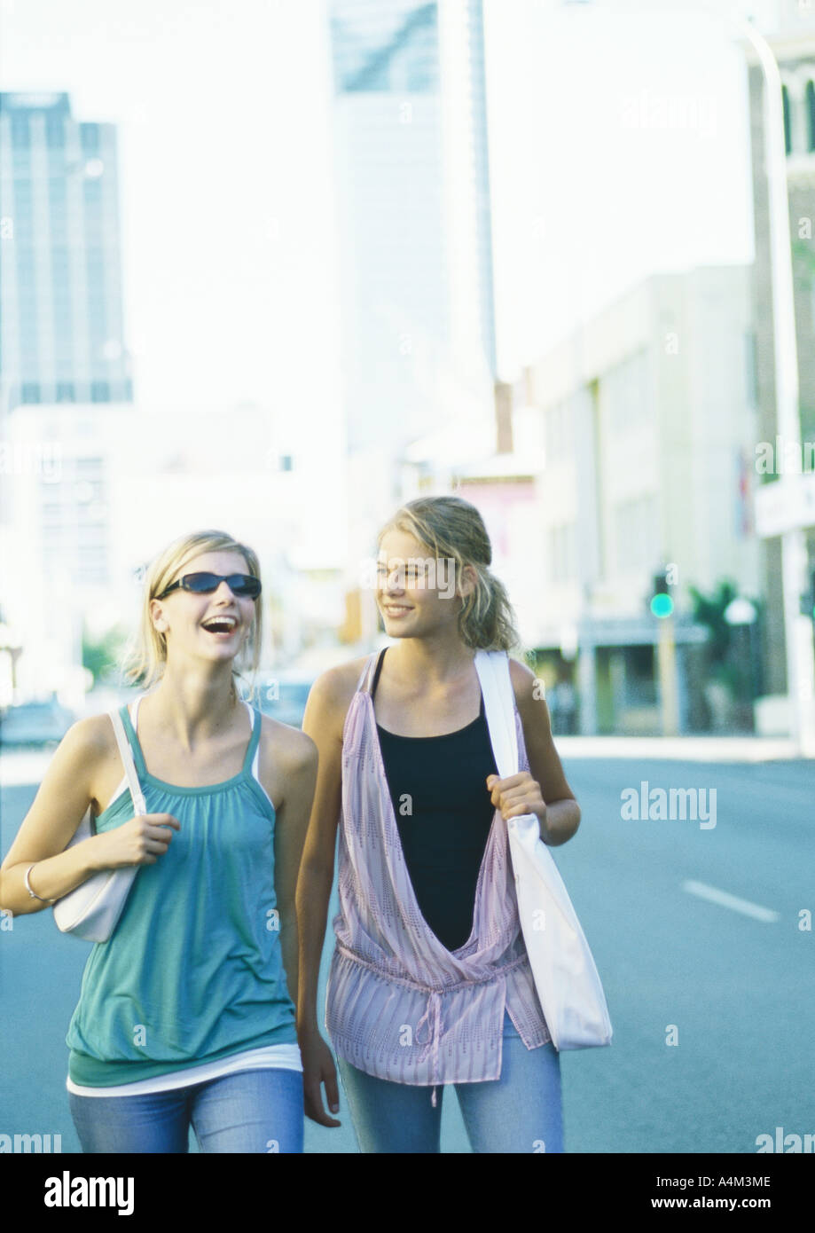 Two teenage girls walking in city Stock Photo - Alamy