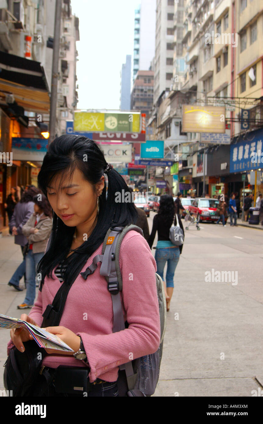 A Korean young female tourist looking at a map in Hong Kong Stock Photo ...