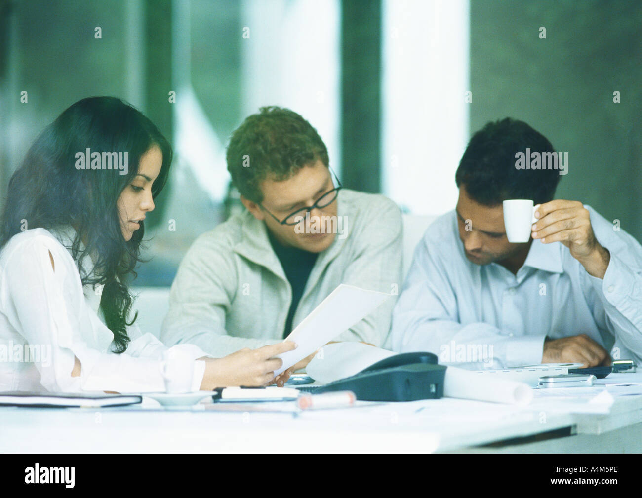 Young adults examining documents Stock Photo