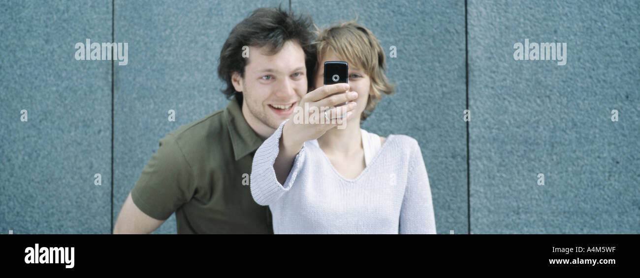 Young couple taking self portrait with camera phone Stock Photo