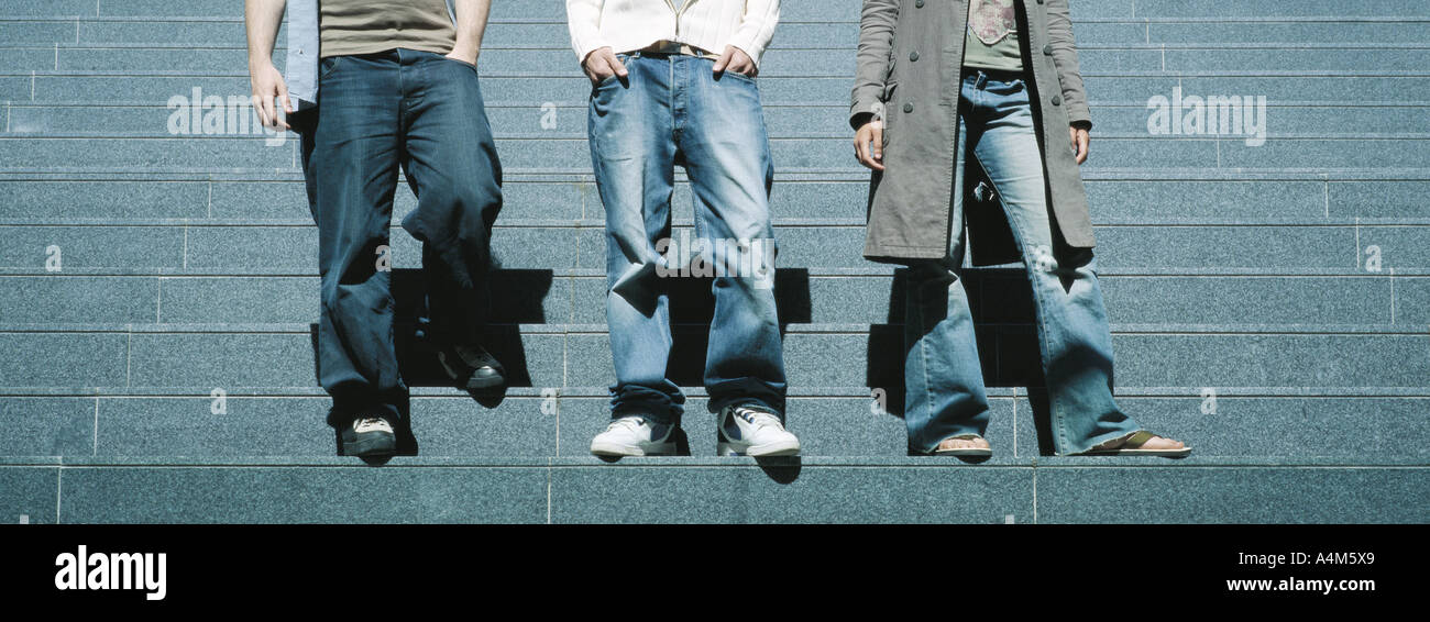 Young people standing on steps, waist down Stock Photo
