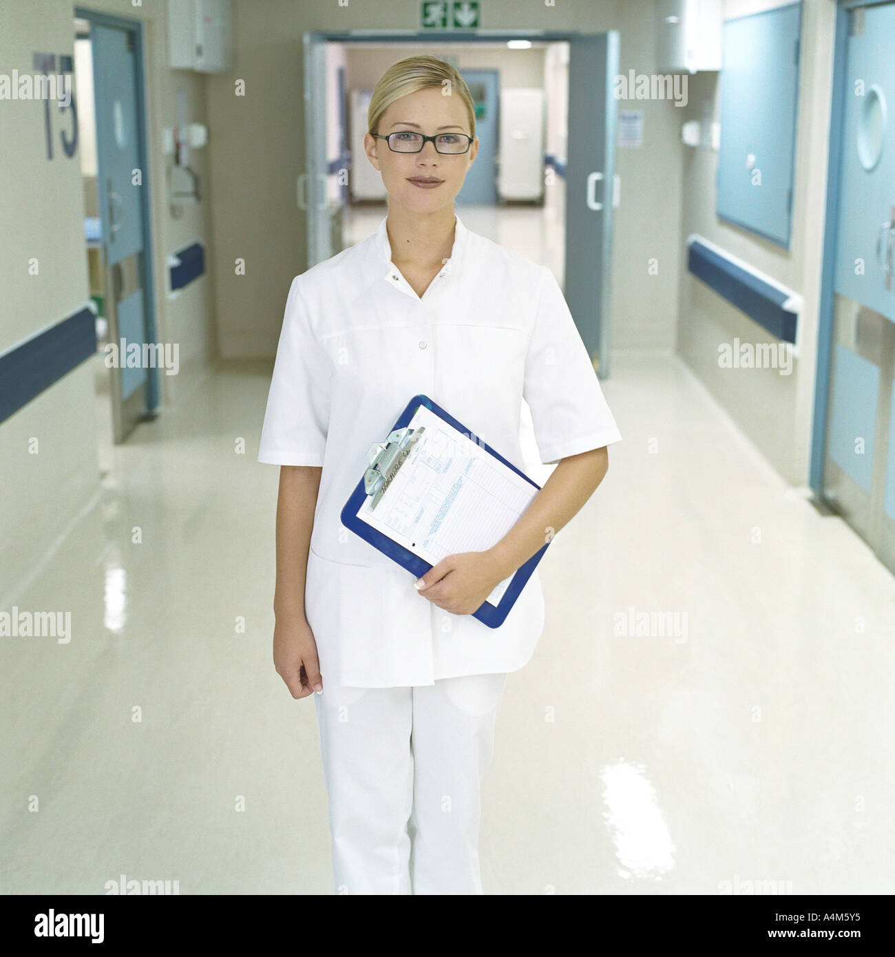 Nurse standing in hospital corridor Stock Photo
