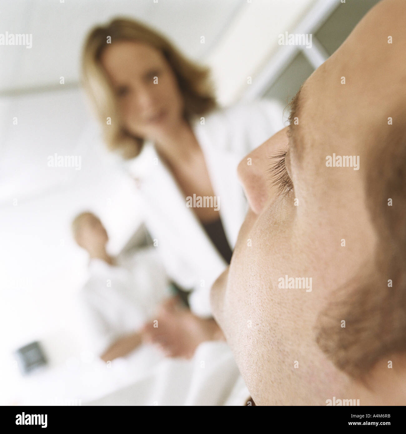Doctor looking down at patient Stock Photo