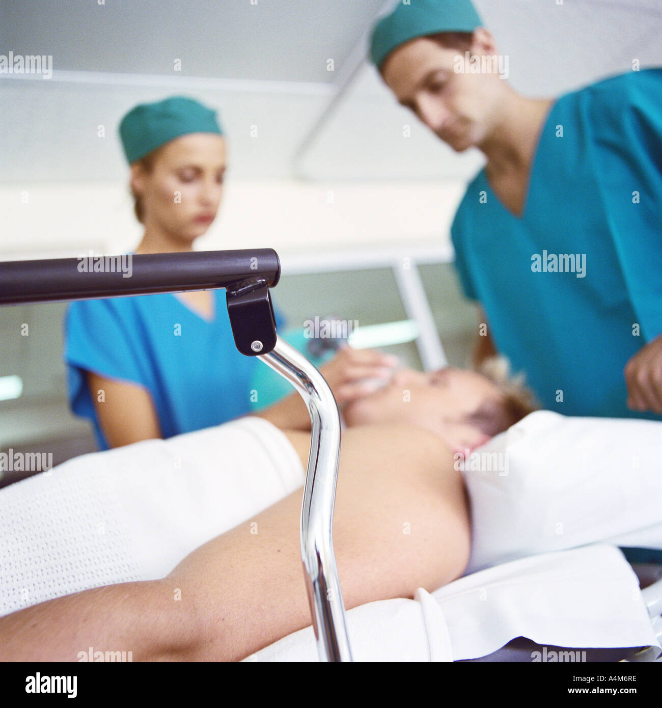 Interns standing over patient Stock Photo